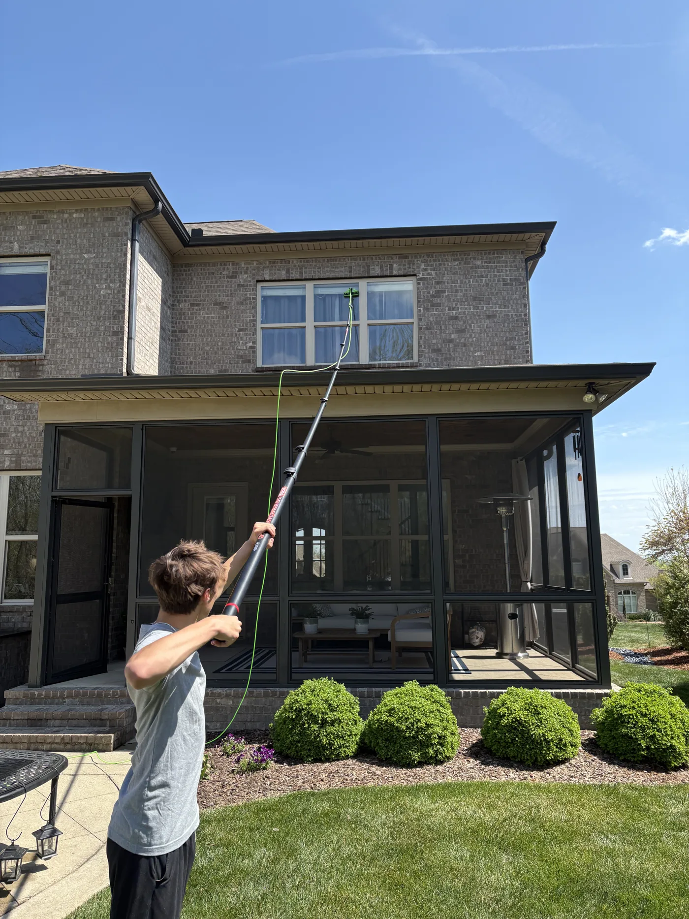 WaveWash technician cleaning residential windows in Nashville